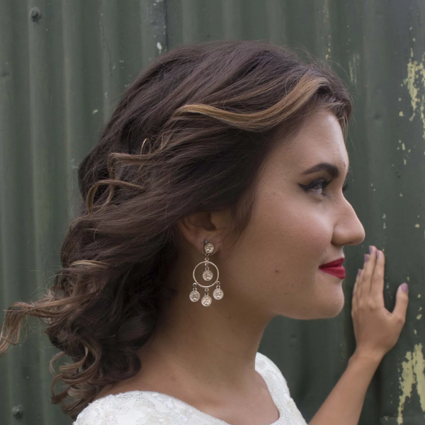 Woman with a modern layered haircut featuring healthy, shiny hair and soft movement.